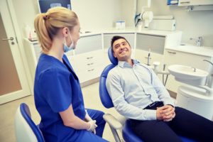dentist talking to patient in office