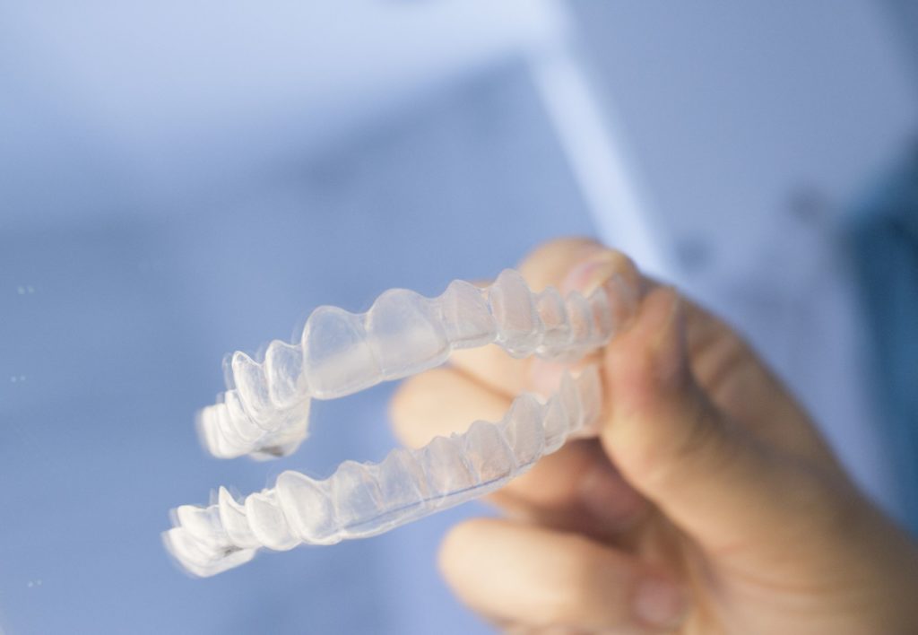 person holding a pair of clear braces
