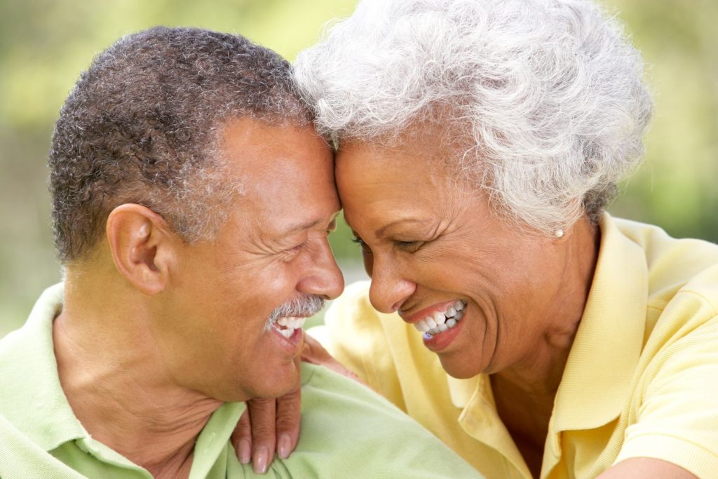 couple with dental implants smiling together